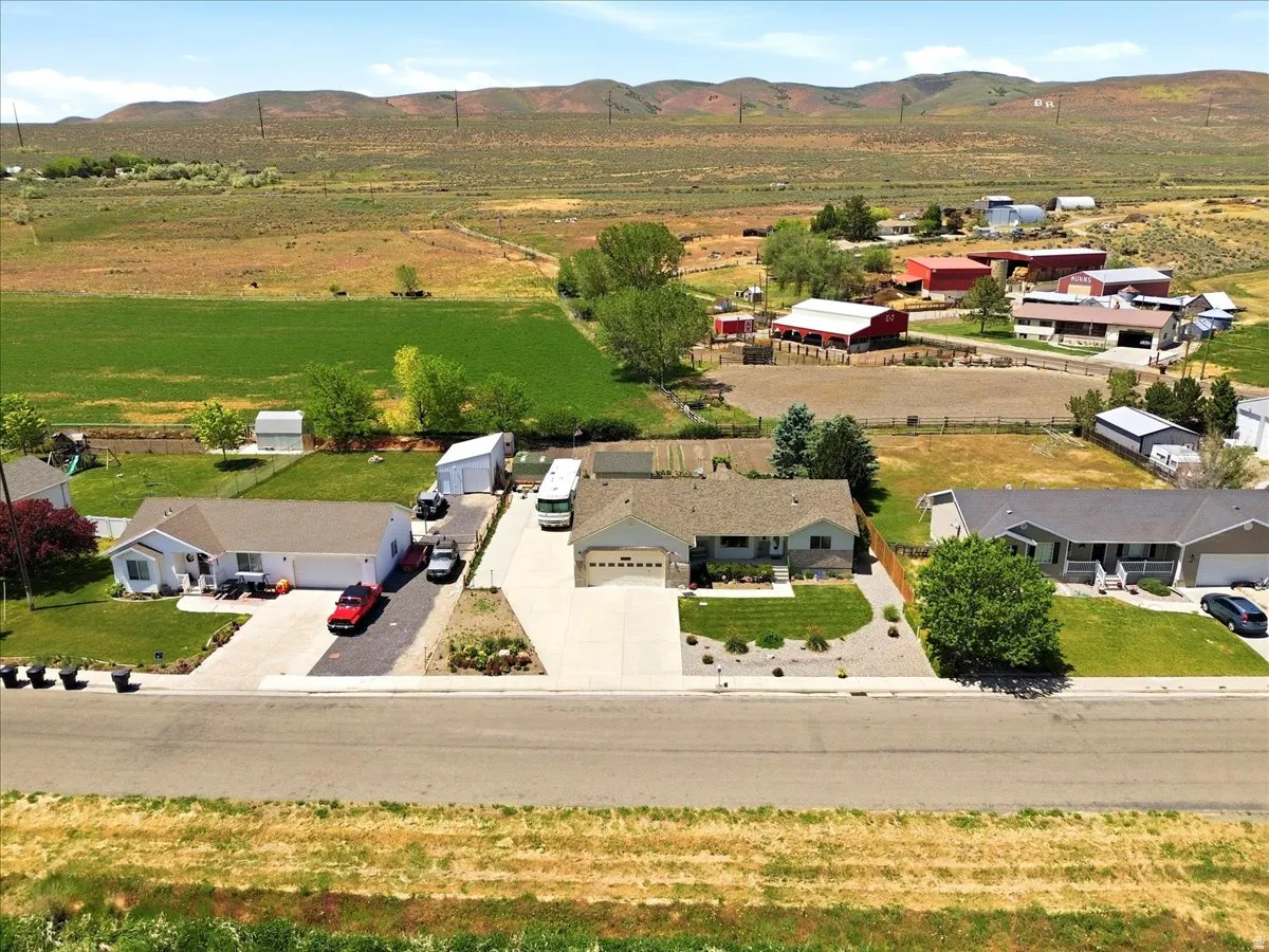 Single-story residence featuring a two-car garage, concrete driveway, and front lawn