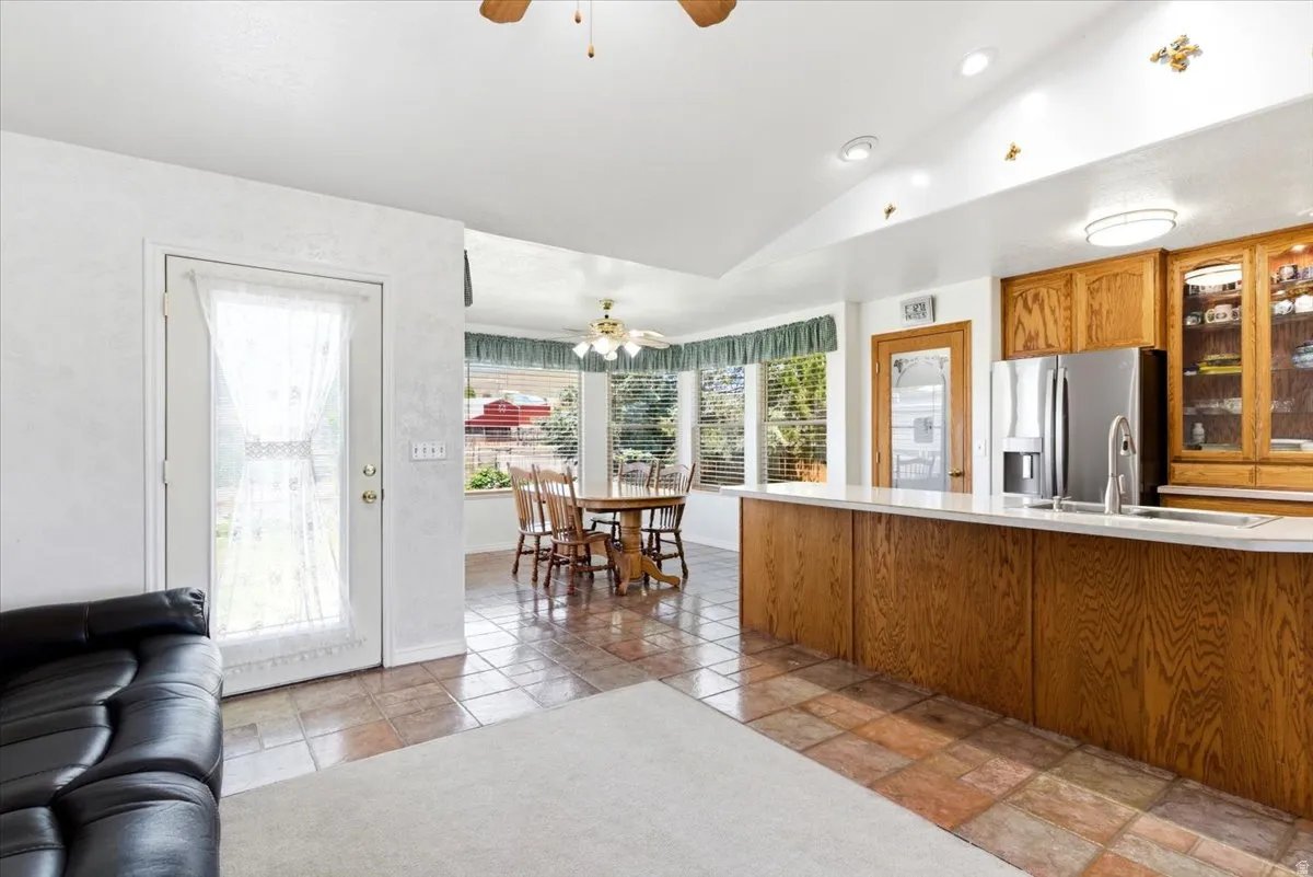 Kitchen featuring wood cabinetry, stainless steel appliances, a white countertop, and recessed lighting