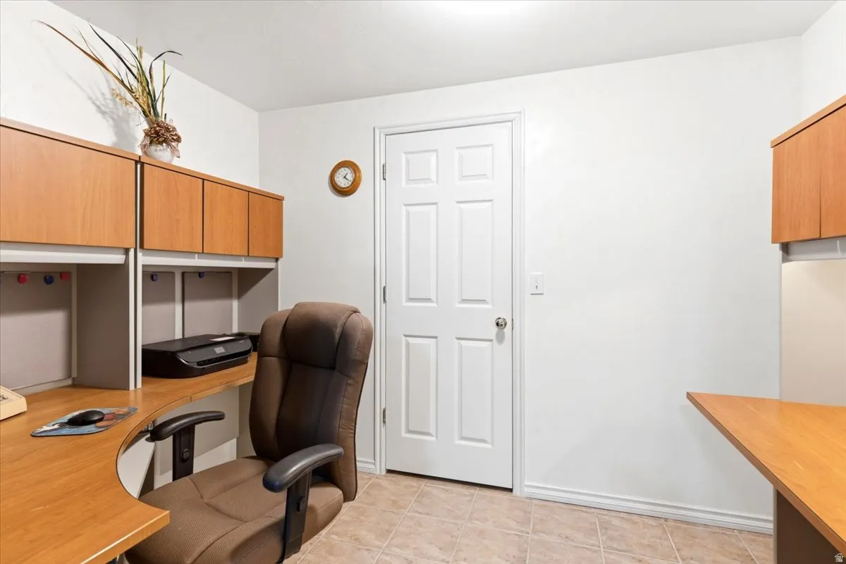 Room featuring light-toned tile flooring and white baseboards