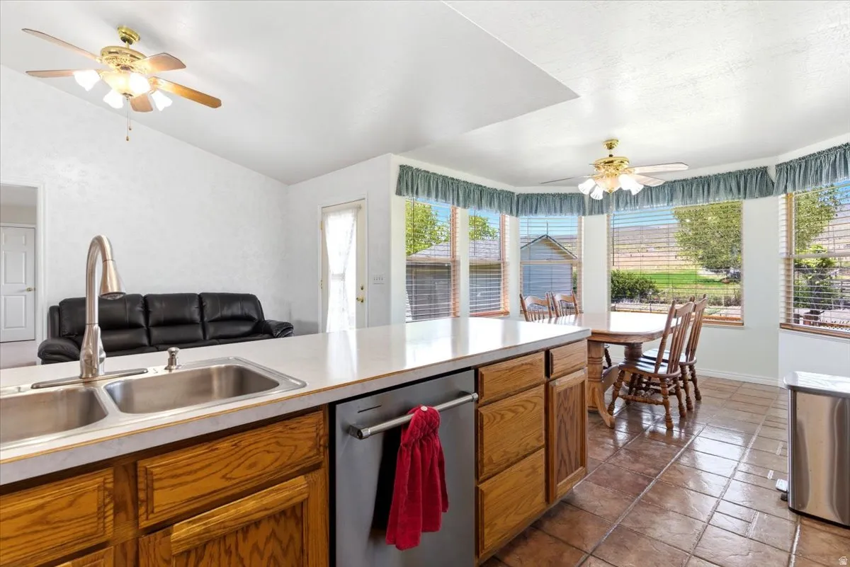 Kitchen island featuring a dual basin stainless steel sink with a gooseneck faucet
