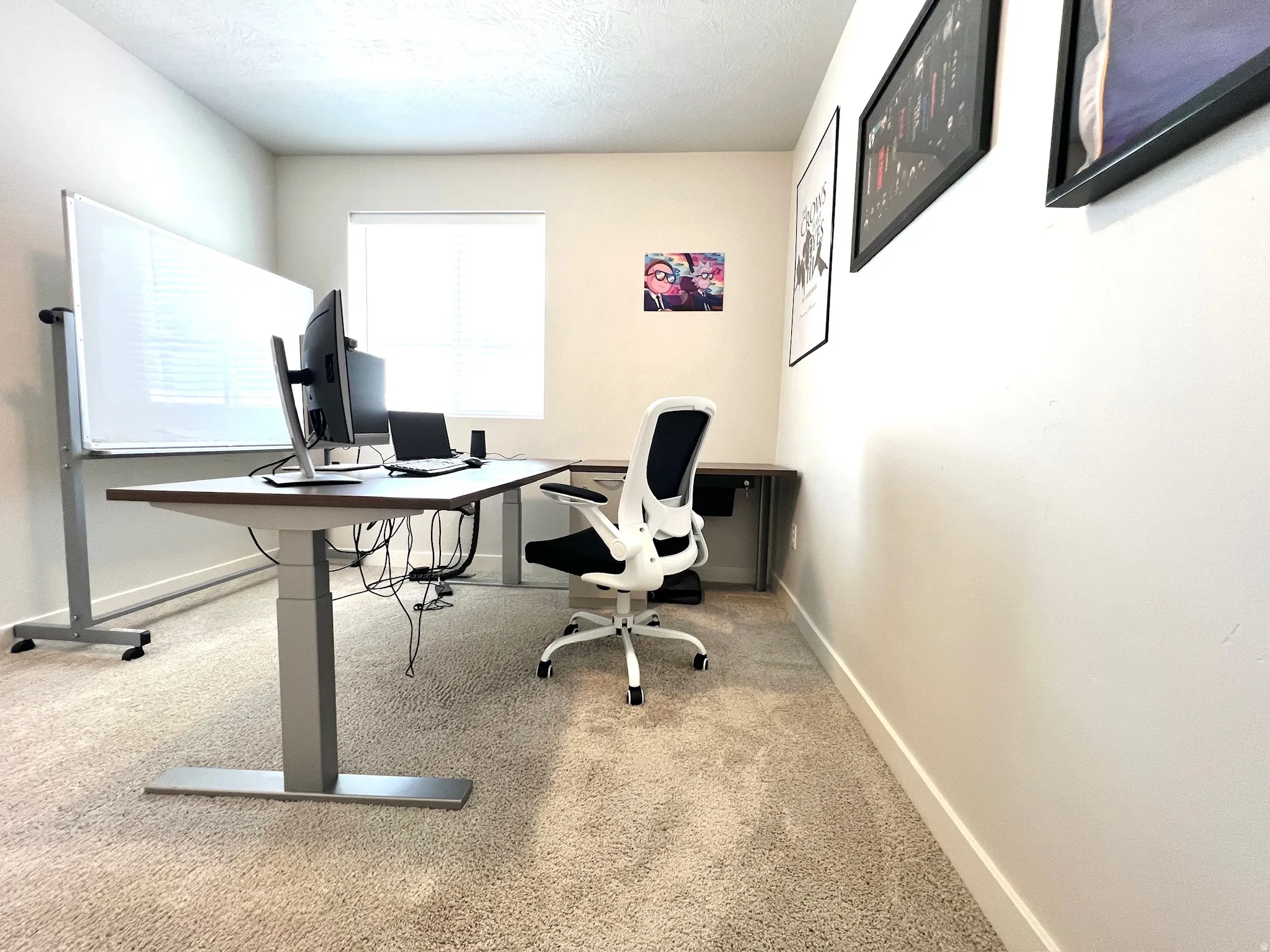 Carpeted room featuring light-colored walls, a window with blinds, and white baseboards