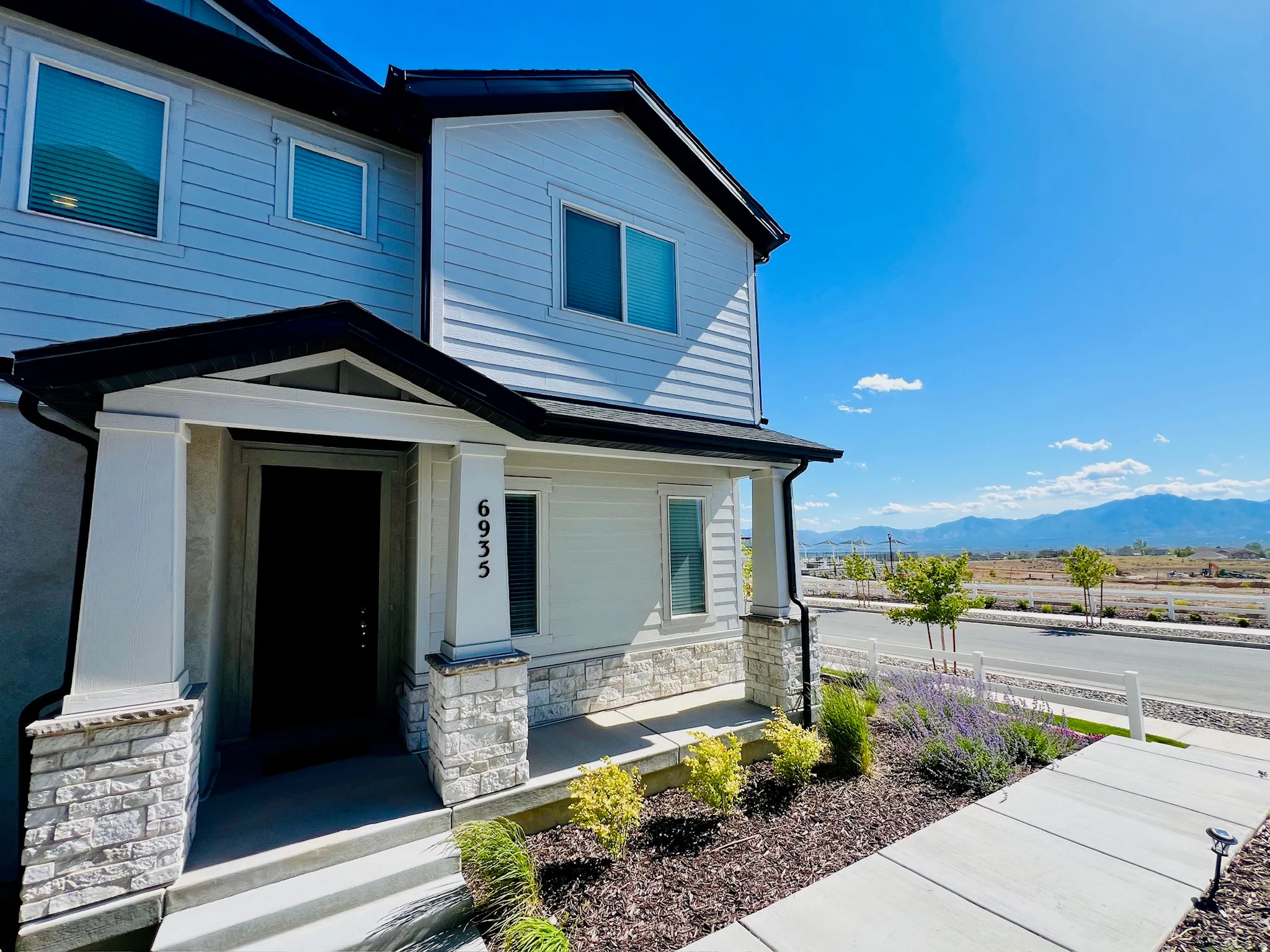 Modern exterior featuring light-toned horizontal siding and black trim