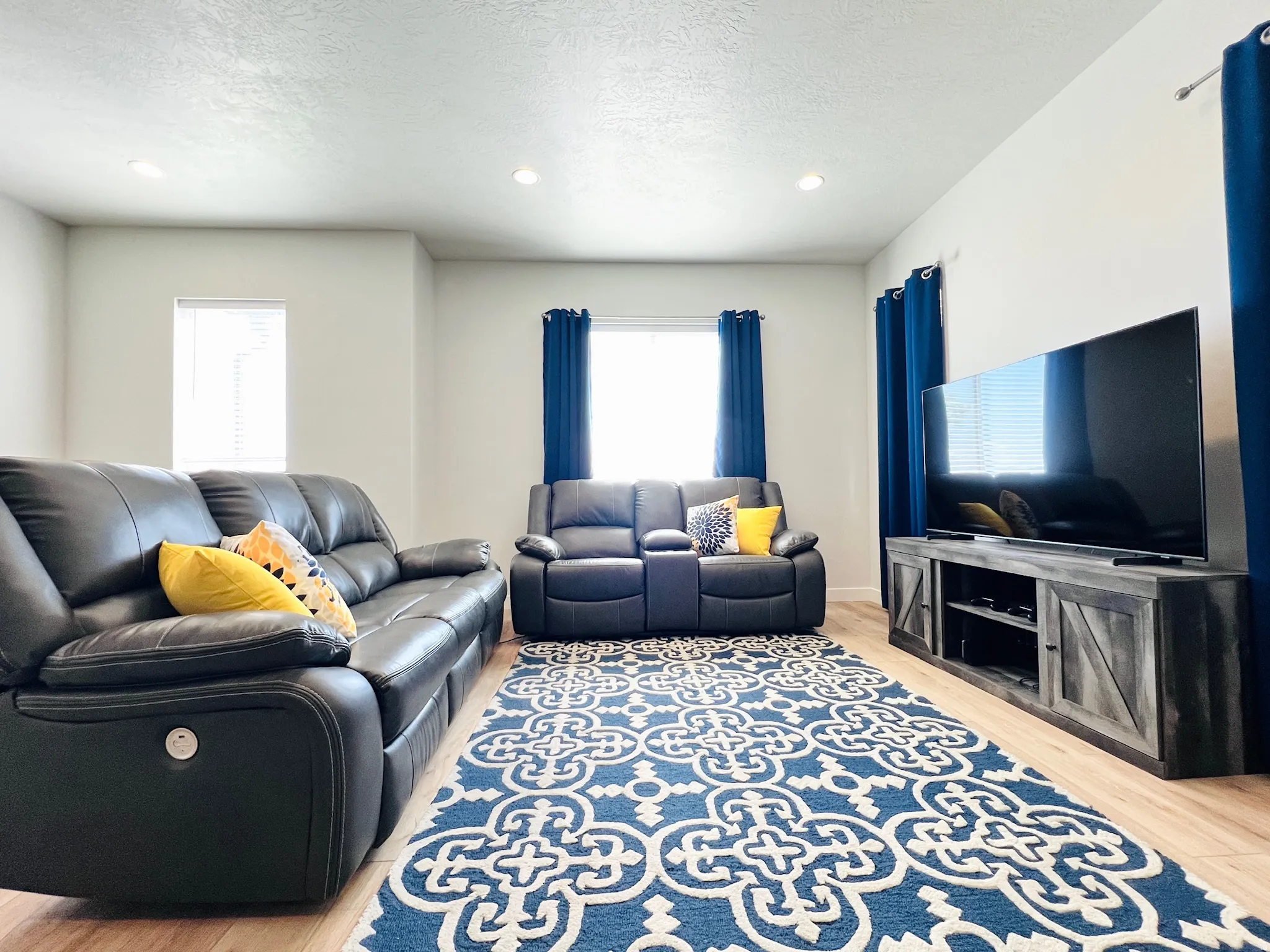Spacious interior featuring light wood-finish flooring and recessed ceiling lights