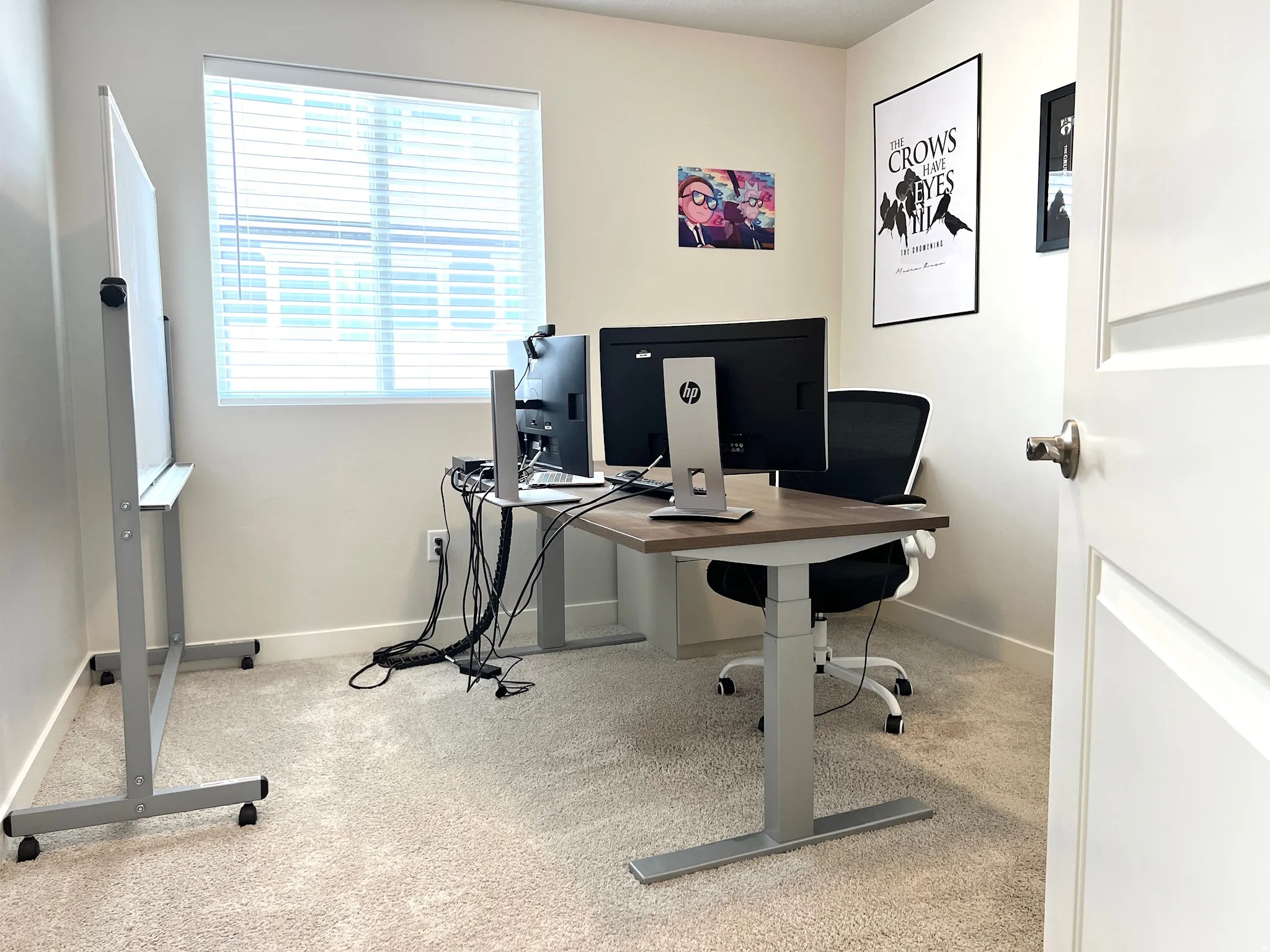 Bright room featuring neutral-toned carpet flooring and a single window with horizontal blinds
