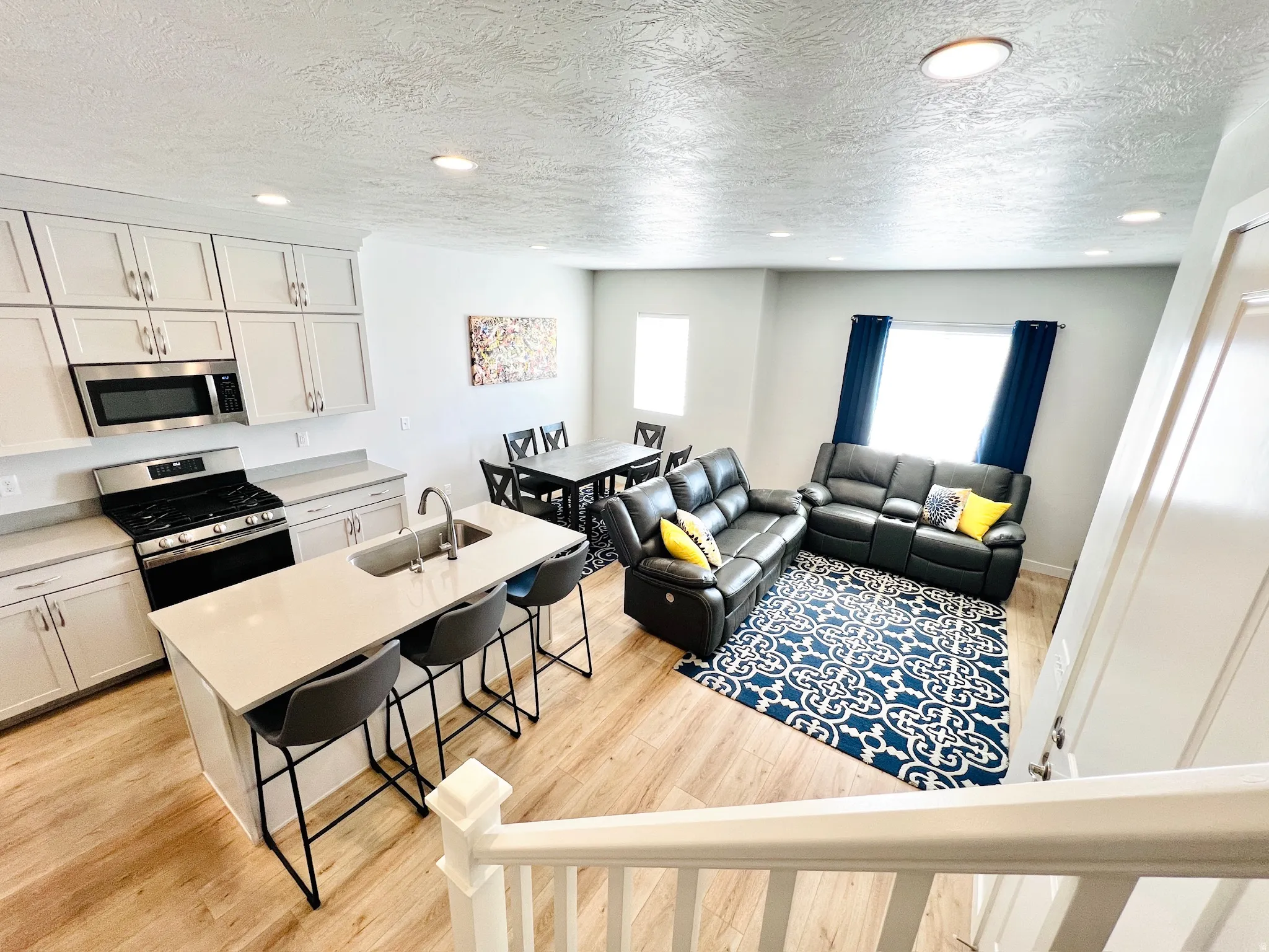 Open-concept living space with wood-finish flooring throughout