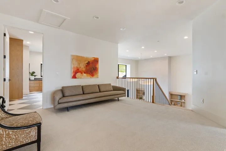 Carpeted upper level with recessed lighting and a white ceiling