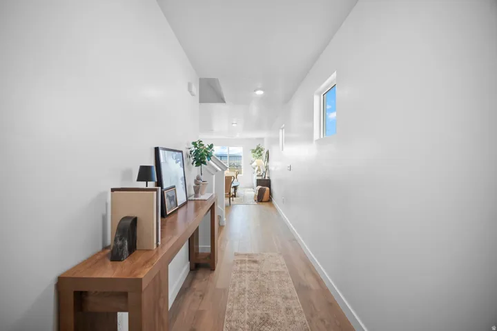 Entryway featuring wood-finish flooring, white walls, and a rectangular window providing natural light
