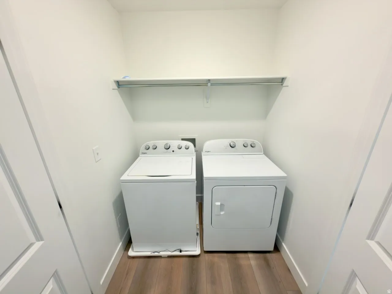 Dedicated laundry space featuring a top-load washer and front-load dryer