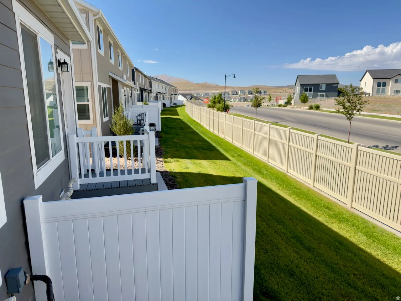 Rear patios with white railings and composite decking