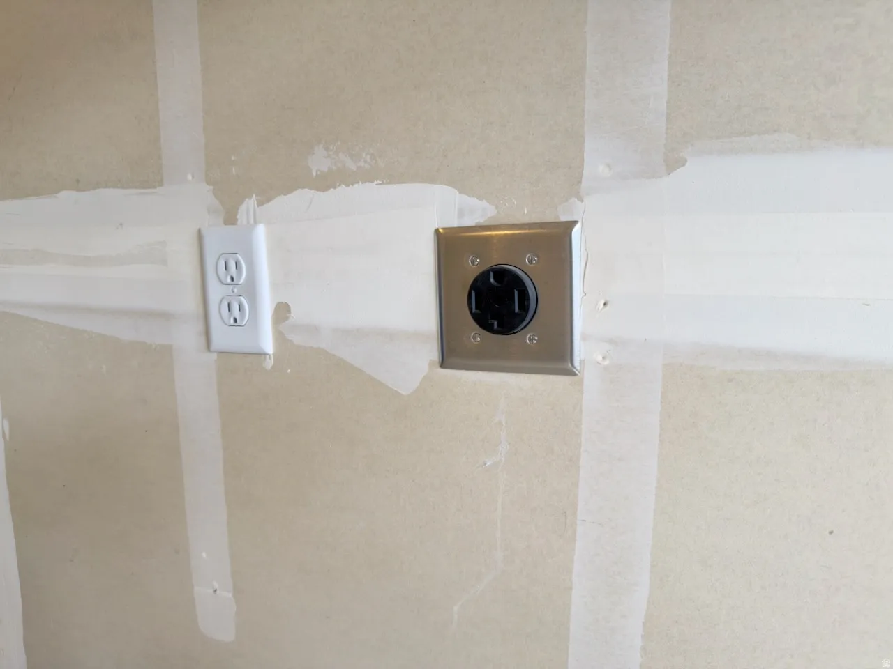 Electrical outlets featuring a standard duplex receptacle and a specialized high-voltage receptacle