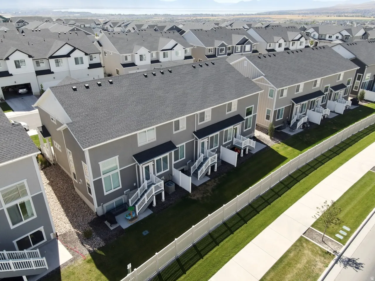 Townhome row featuring dark shingle roofs and light gray siding
