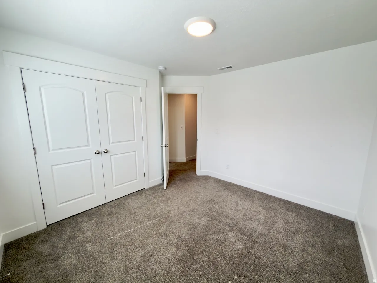 Neutral-toned carpeting paired with white walls