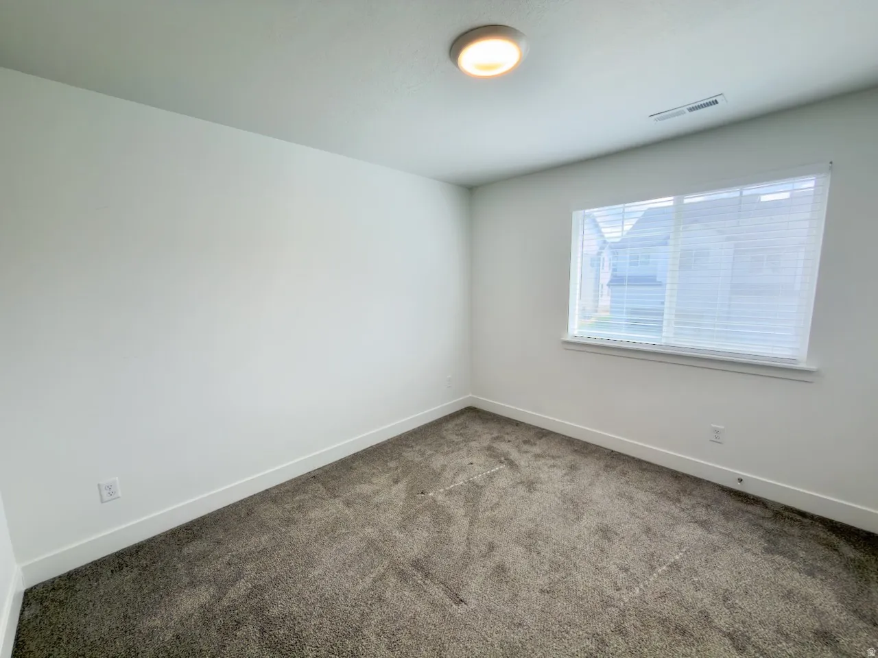 Neutral-toned carpeting and white walls