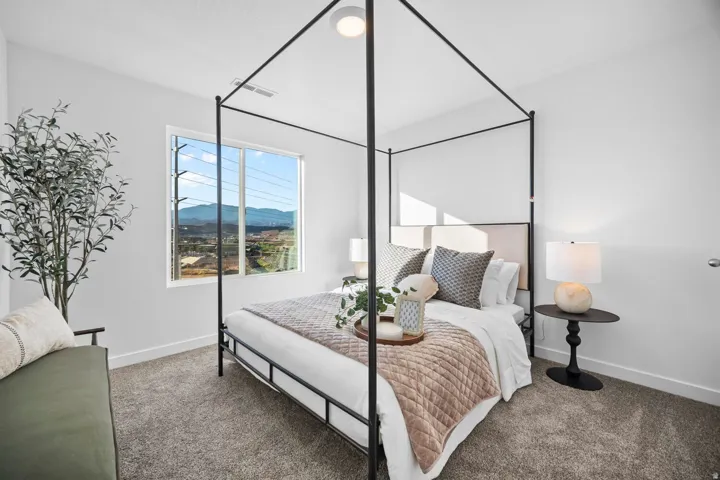 Bright room featuring a large picture window, light gray carpeting, and white walls