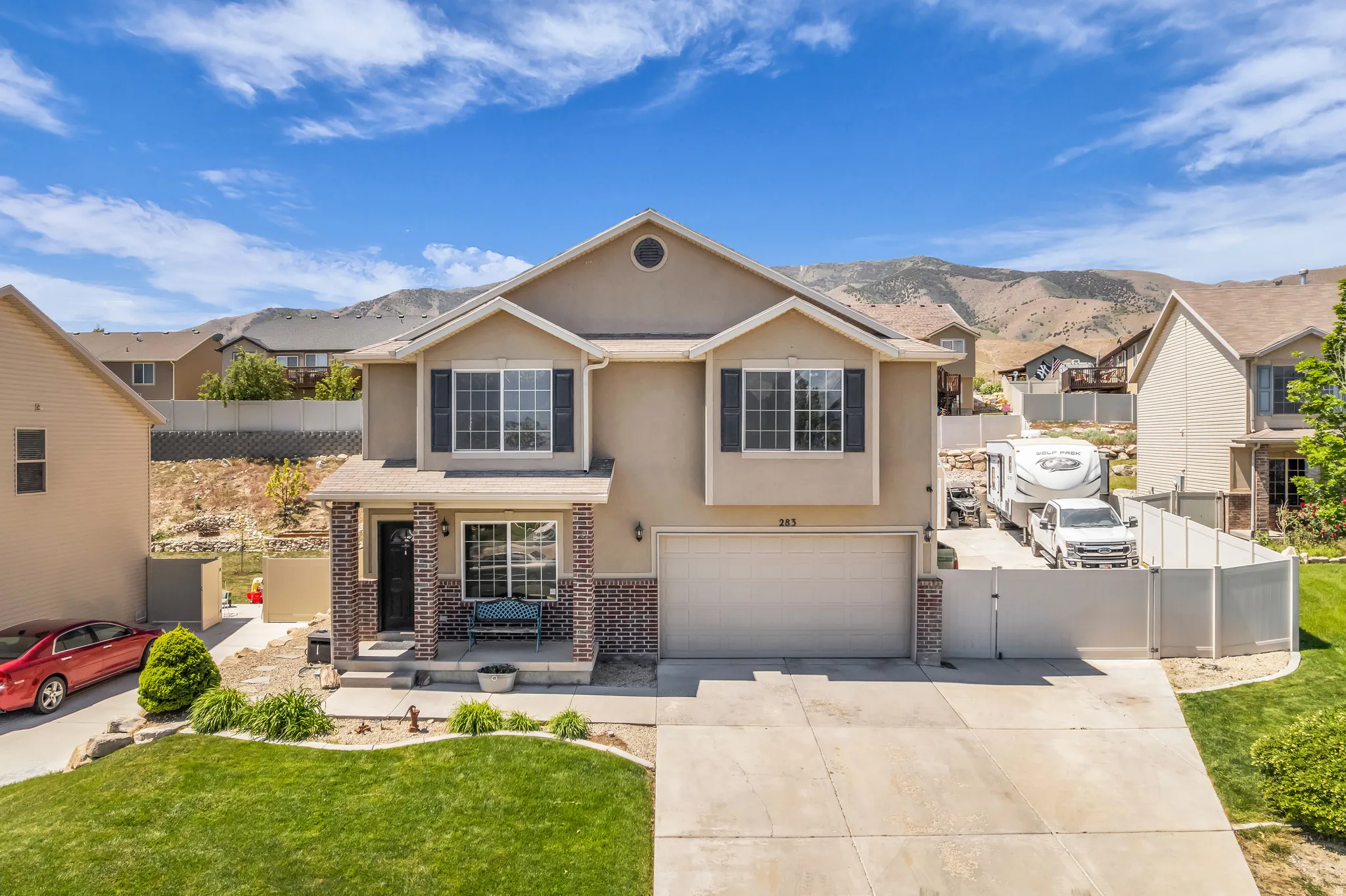Two-story stucco and brick-front residence with an attached two-car garage