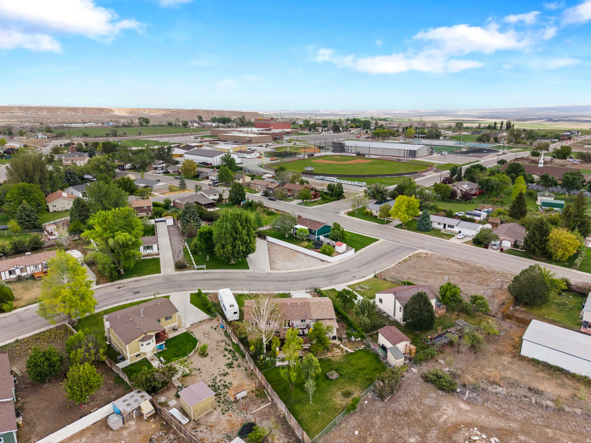 Aerial view of a residential neighborhood with established homes and mature trees