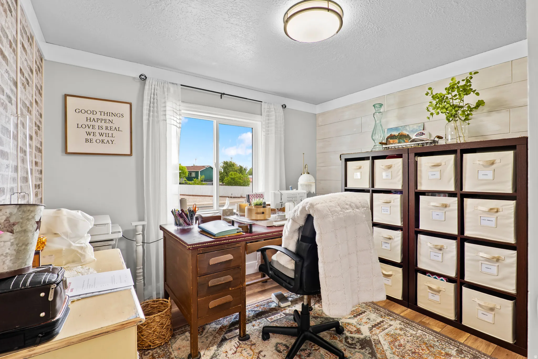 Dedicated room featuring a large window, recessed lighting, and wood-finish flooring