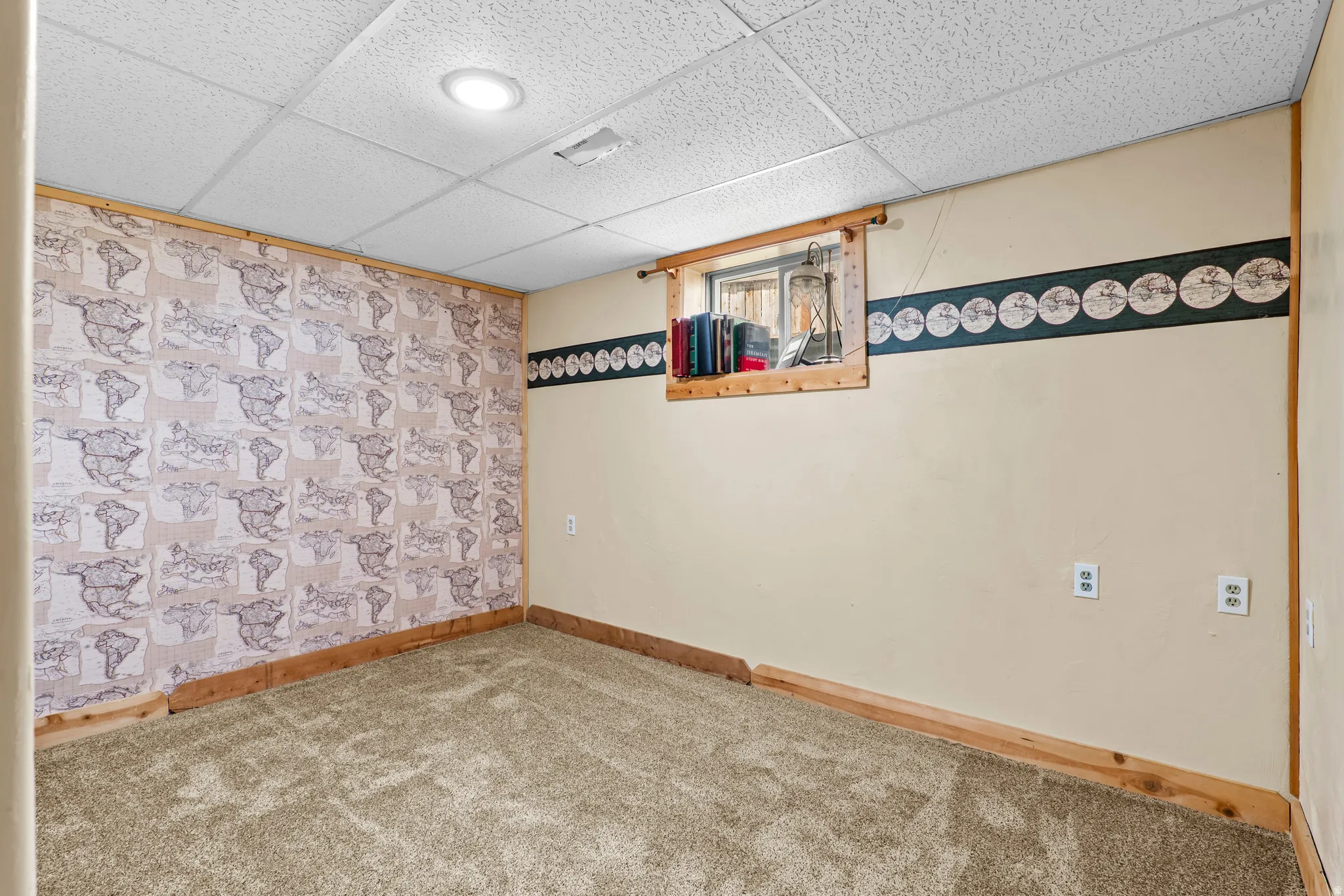 Carpeted room featuring a drop ceiling with recessed lighting