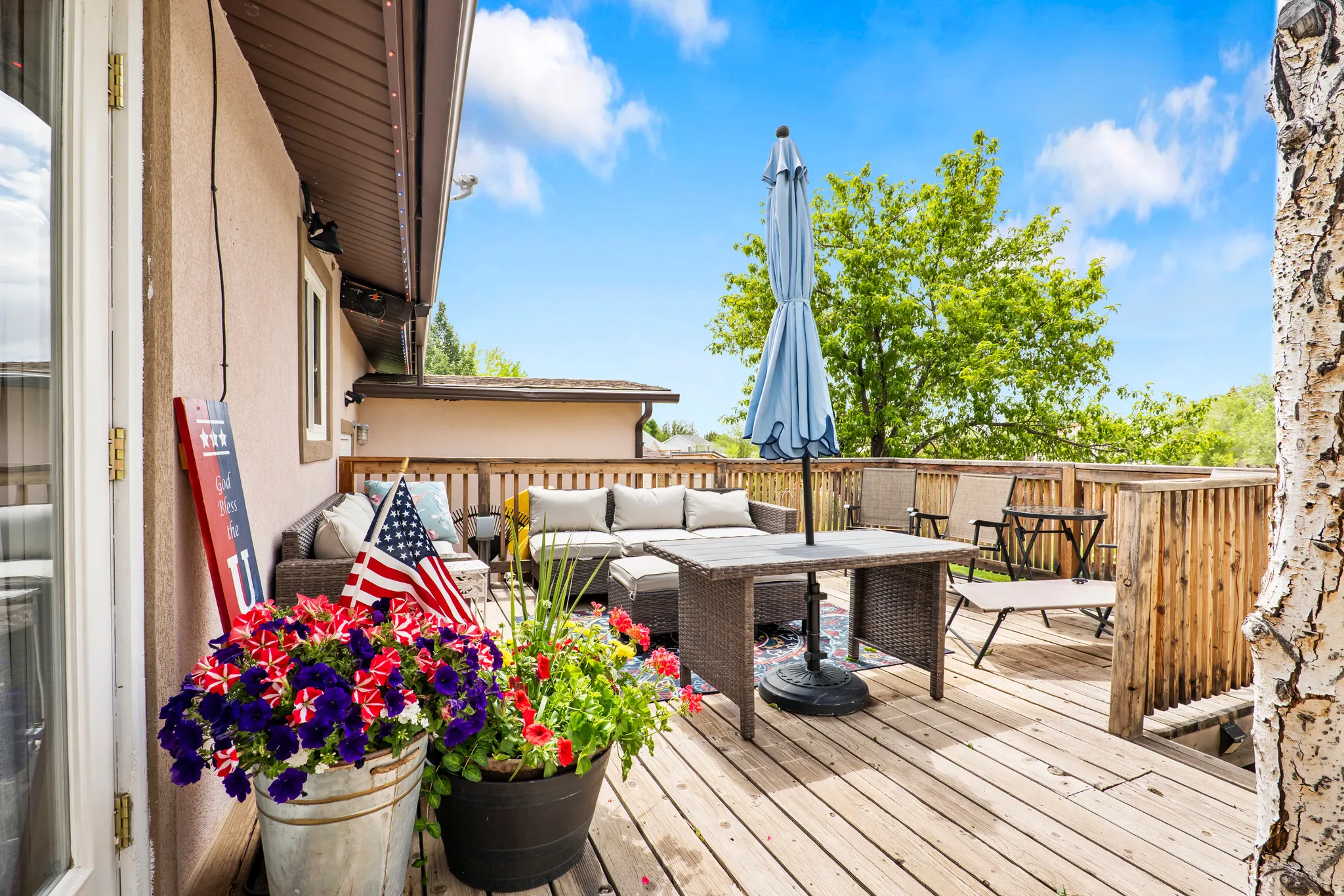 Expansive outdoor deck featuring wood-finish flooring and a wood railing