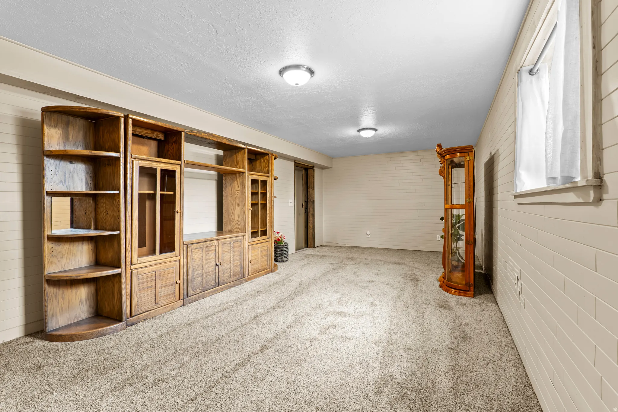 Spacious room featuring extensive built-in wooden shelving and cabinetry