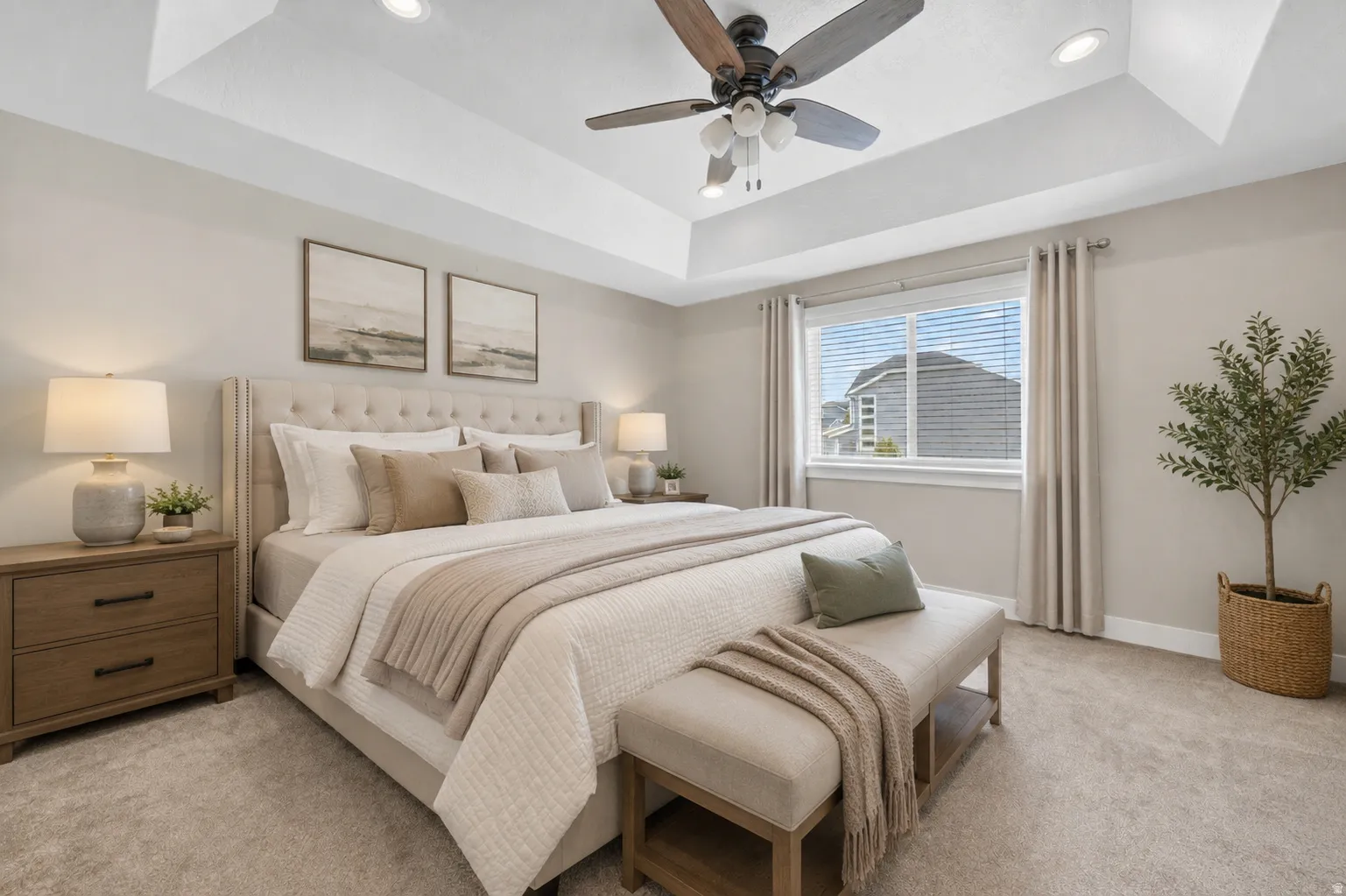 Recessed lighting illuminates a tray ceiling with a ceiling fan