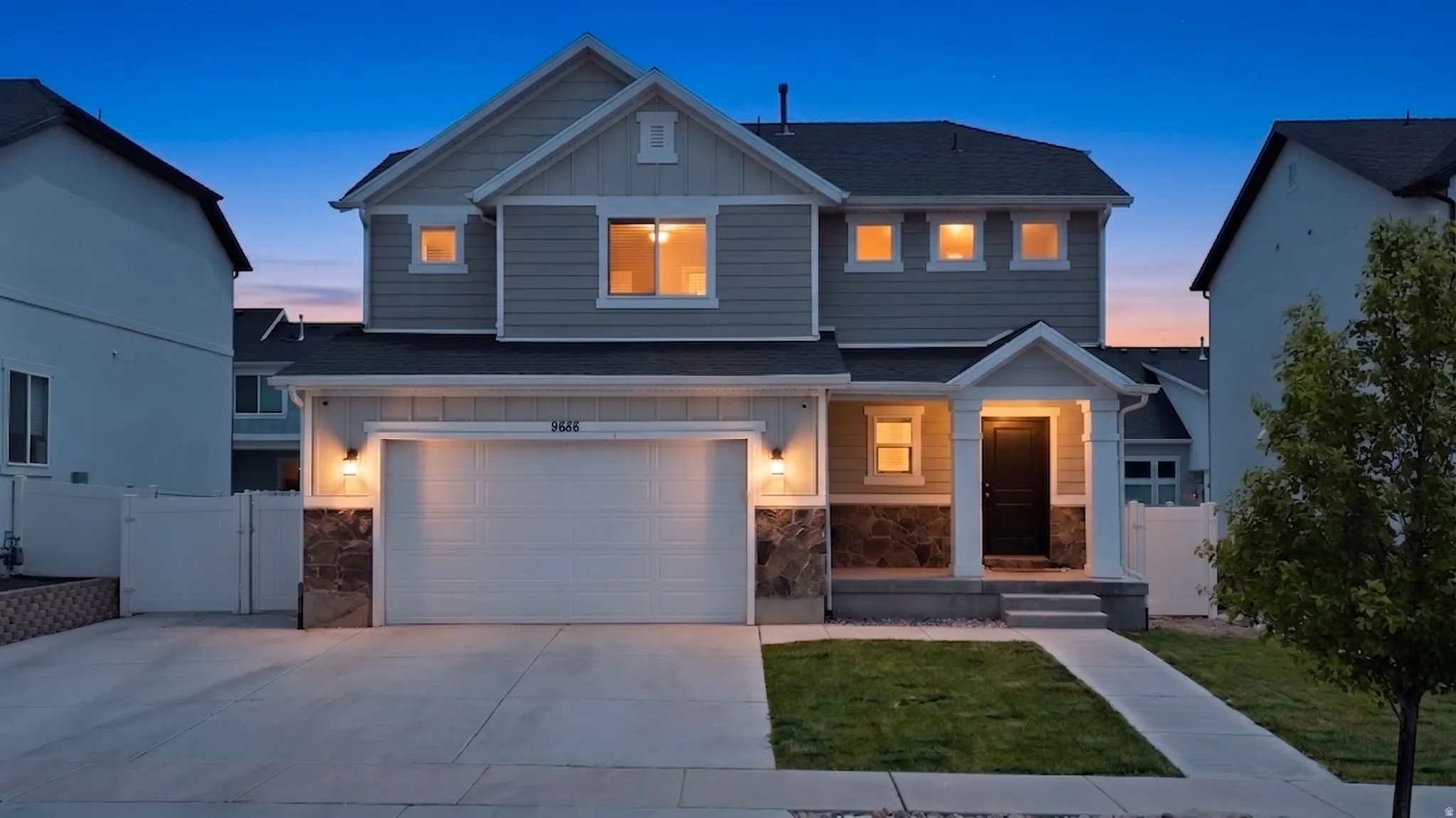 Contemporary two-story residence with a covered front porch and stone accents