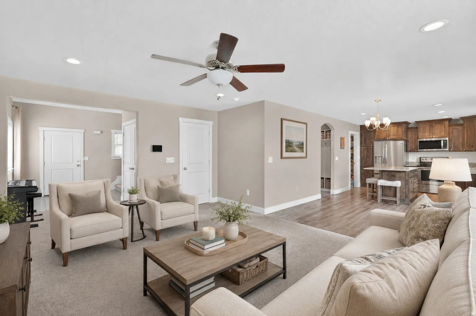Open-concept living space featuring recessed lighting, a ceiling fan, and light-toned carpeting