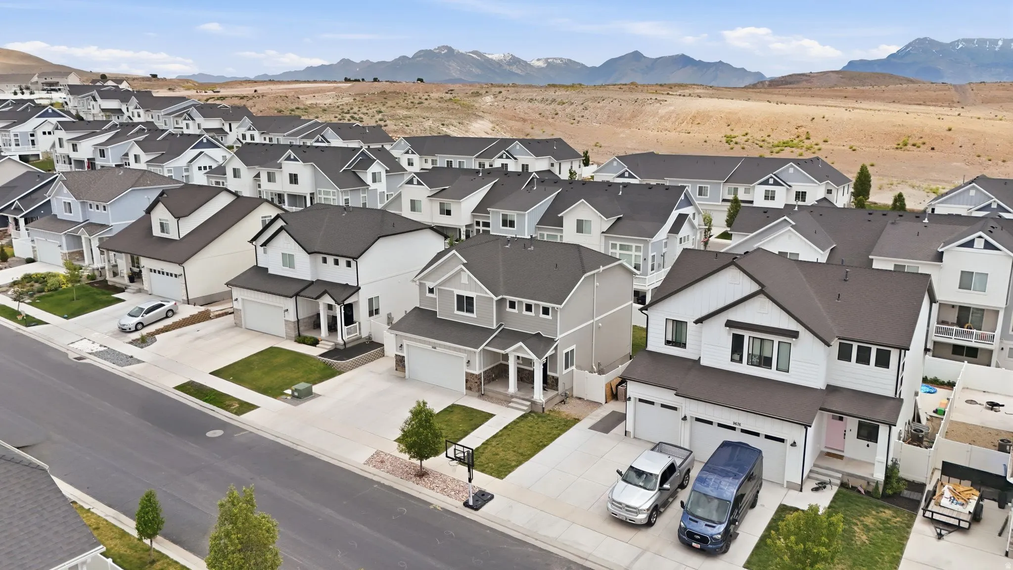 New construction residential development featuring a mountain backdrop