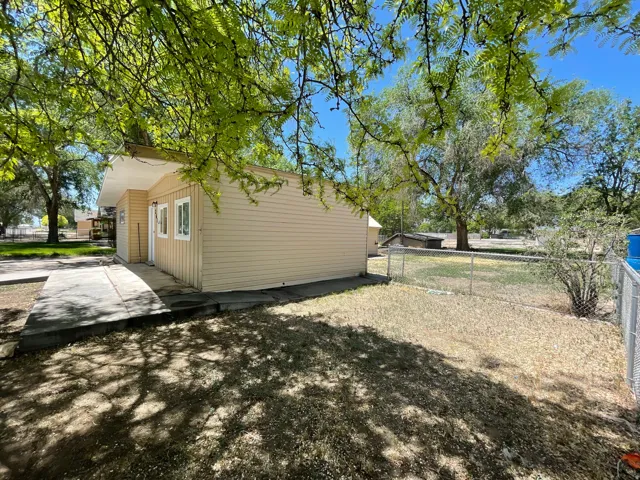 Exterior with horizontal siding, multiple windows, and a concrete pathway