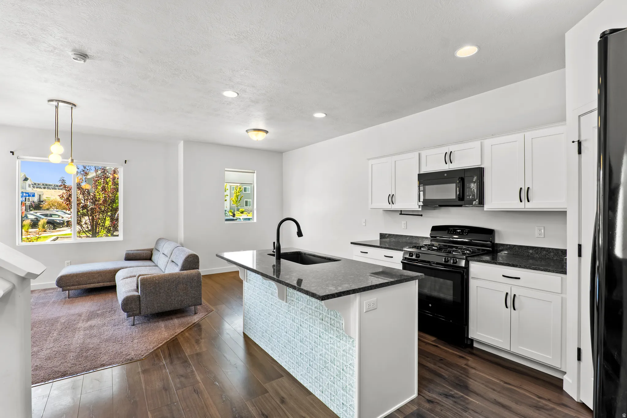 Open-concept living area with dark wood-finish flooring