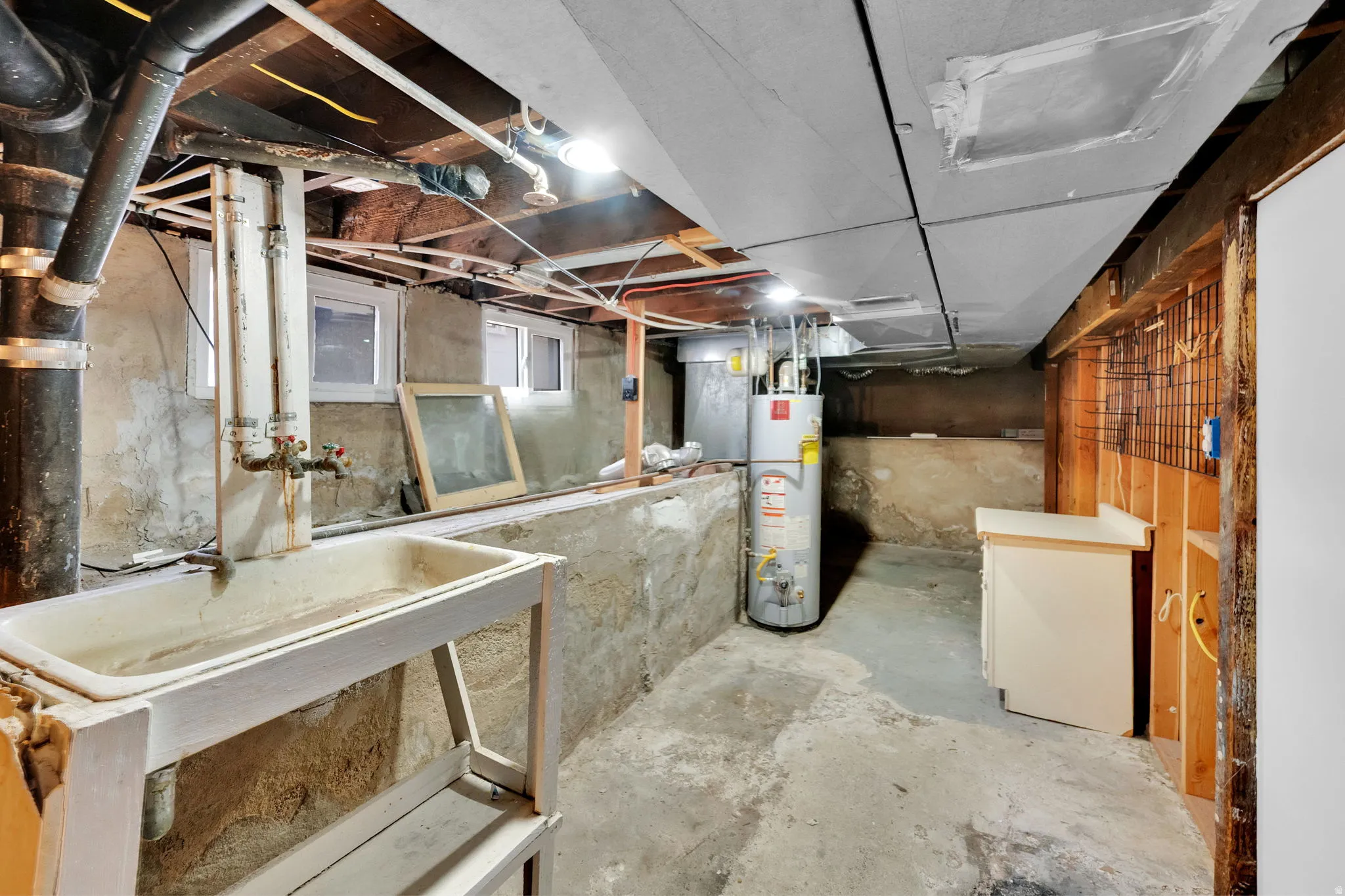 Expansive basement with concrete flooring and exposed ceiling joists