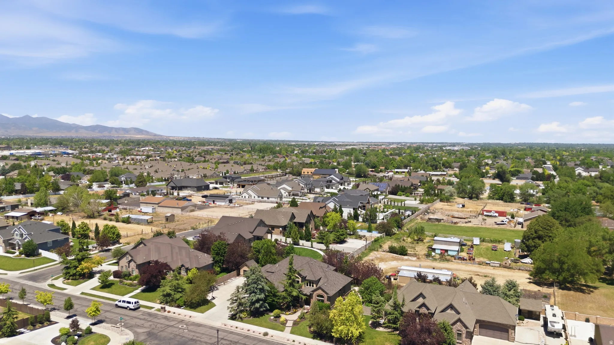 Expansive residential area featuring a variety of architectural styles, mature landscaping, and mountain backdrop