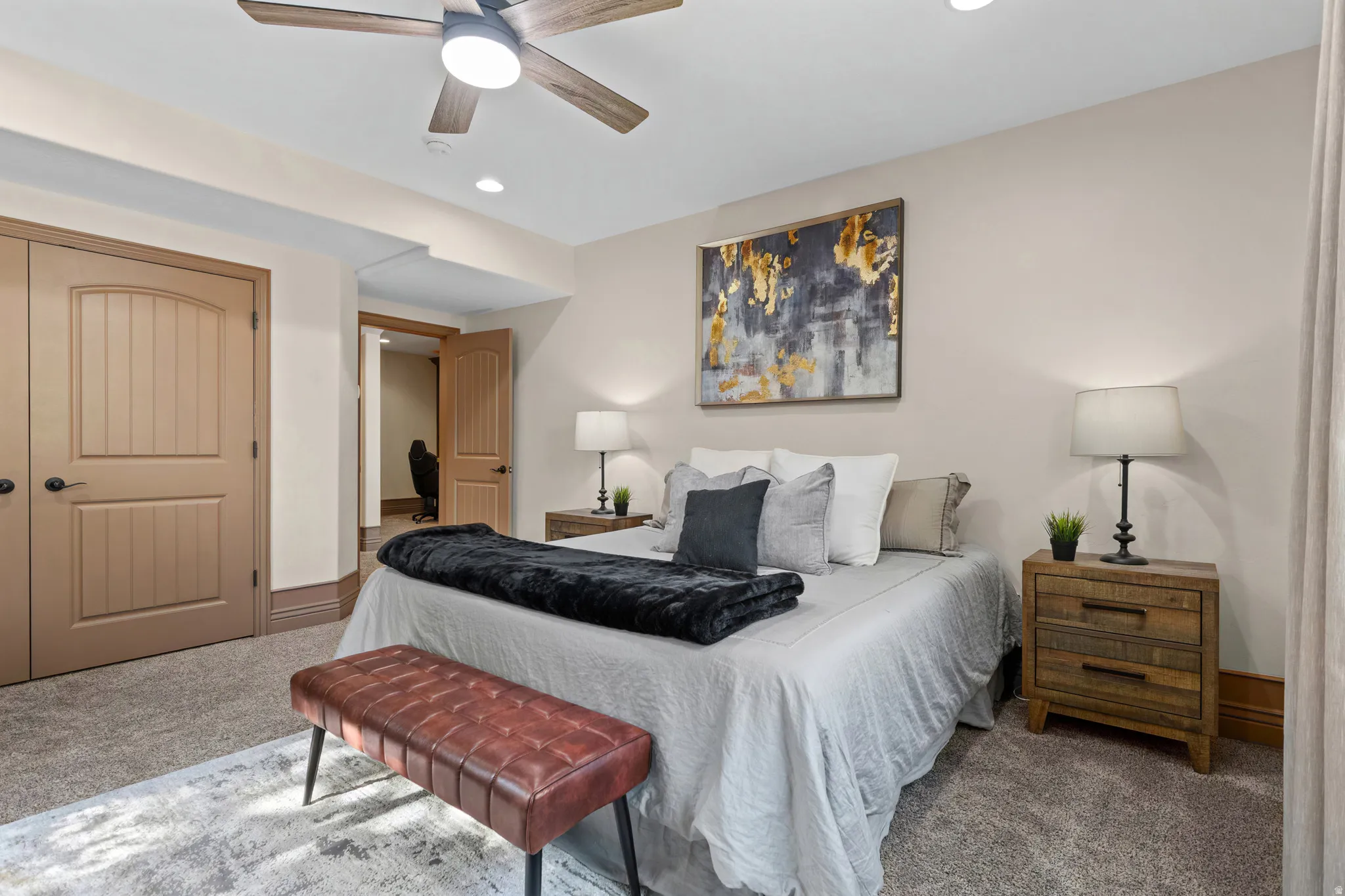 Spacious bedroom featuring neutral wall tones, recessed lighting, and a ceiling fan