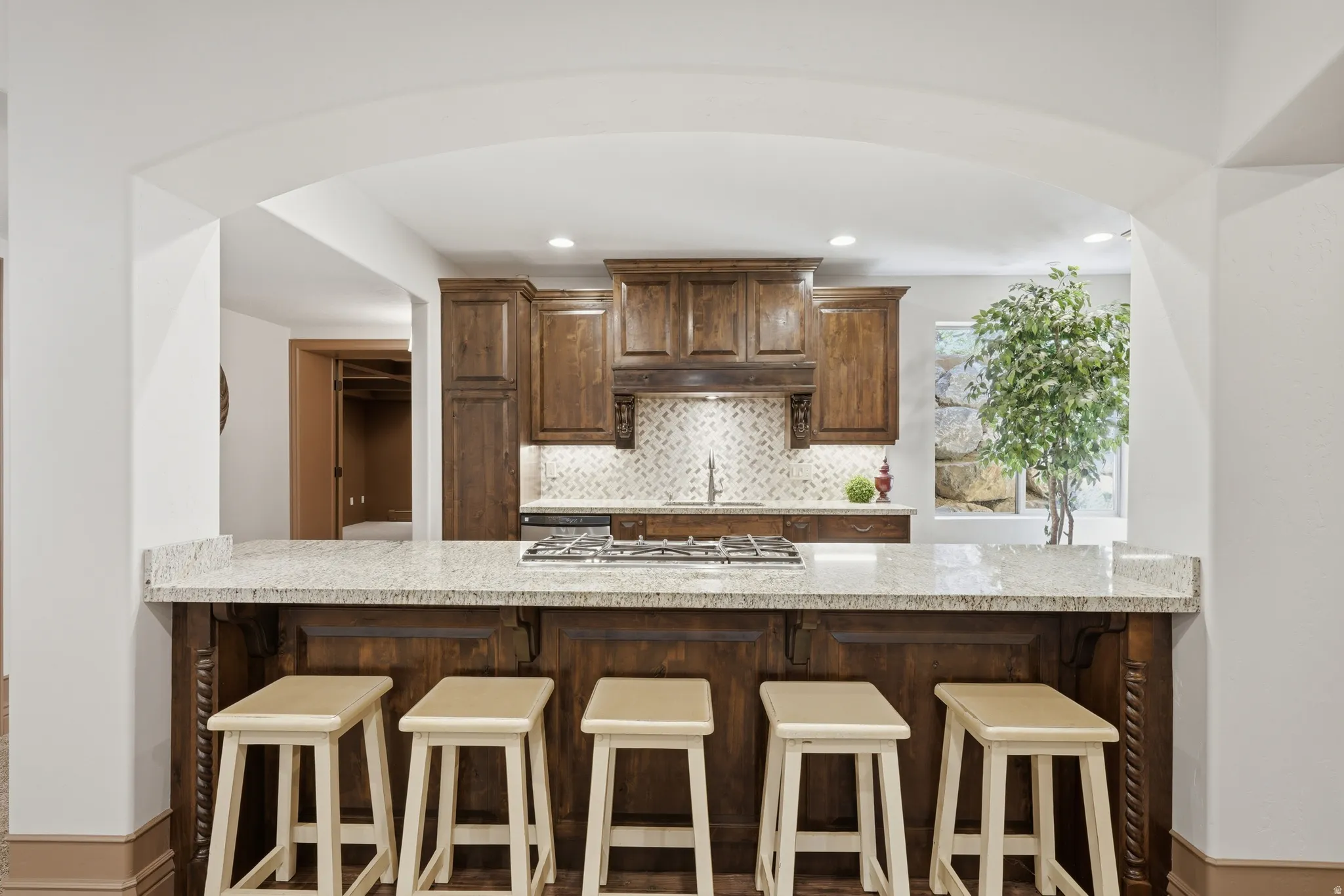 Kitchen island with granite countertop and custom wood cabinetry.