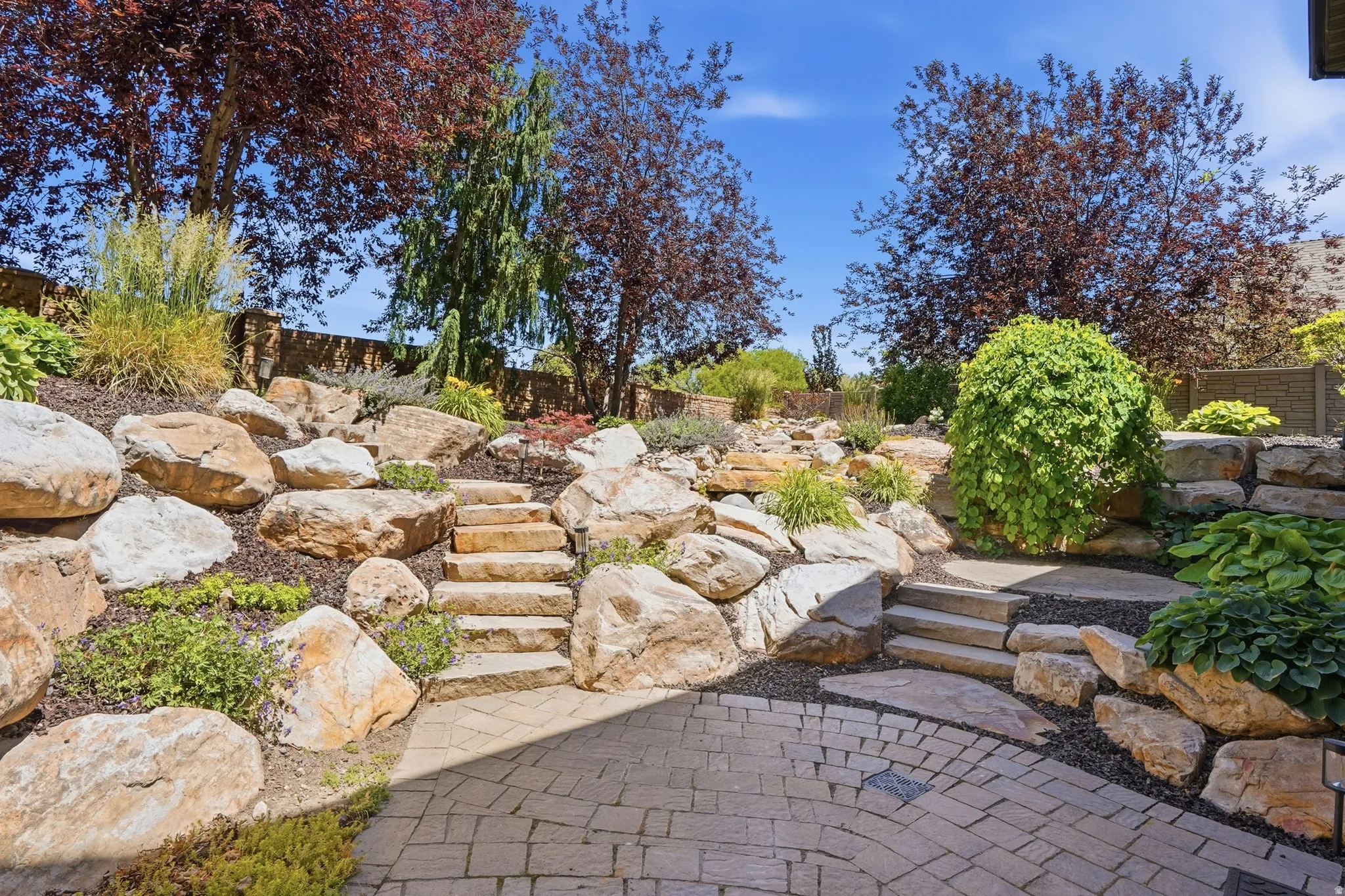 Terraced landscaping featuring natural stone retaining walls and steps