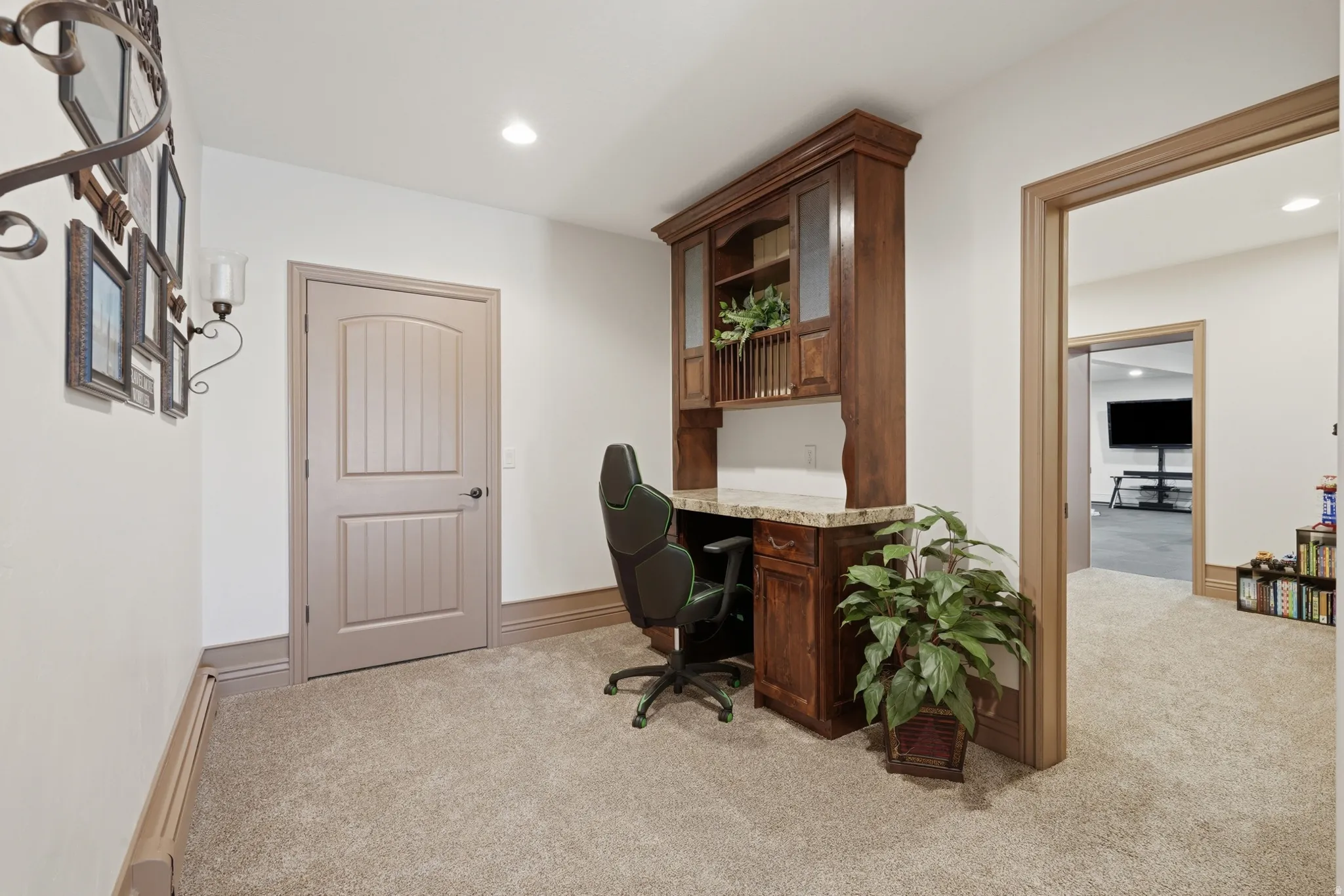 Built-in wood cabinetry with glass fronts and a stone countertop