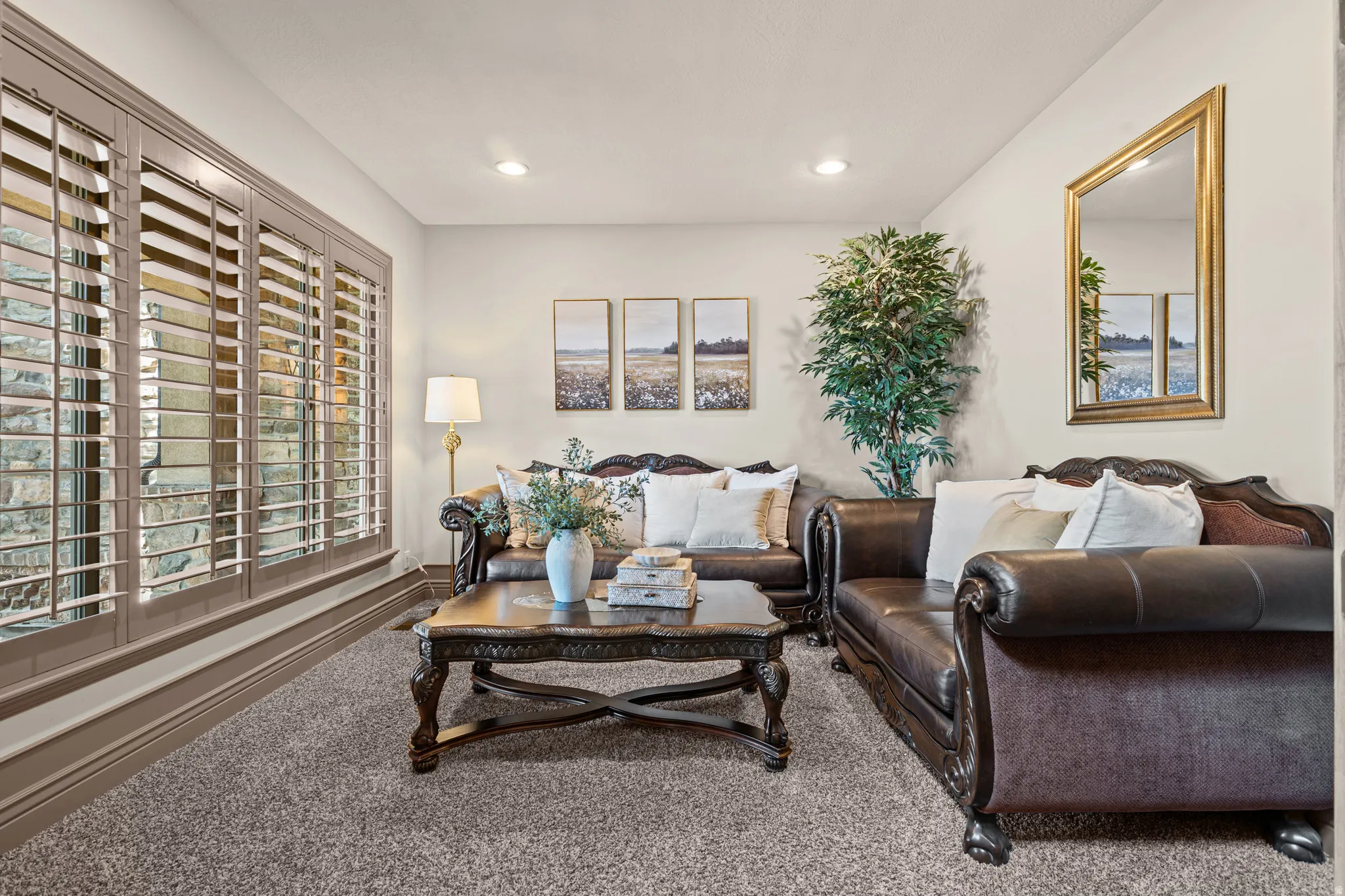 Living area with neutral wall finishes and recessed lighting