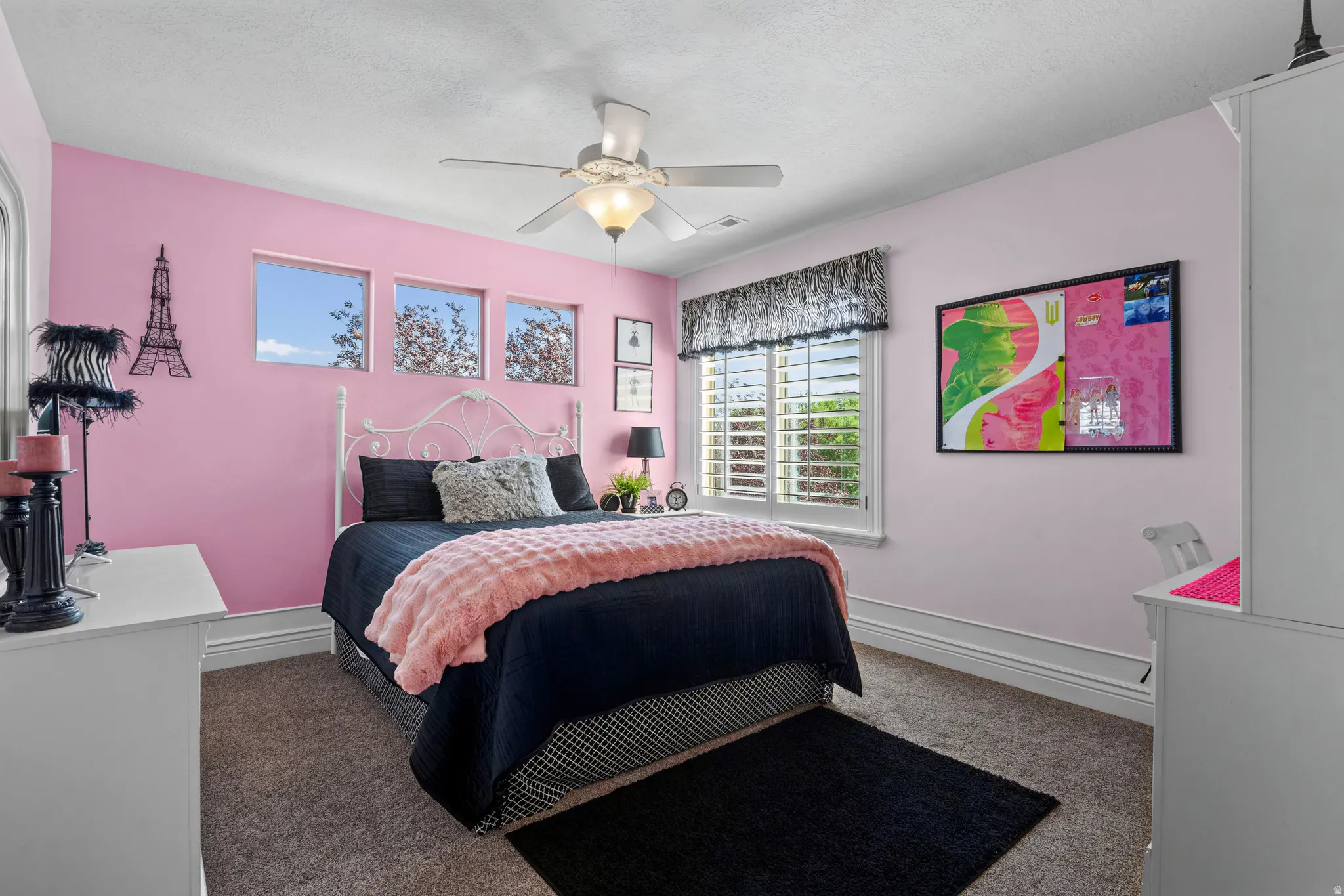 Bedroom featuring a ceiling fan with integrated lighting, wall-to-wall carpeting, and multiple windows