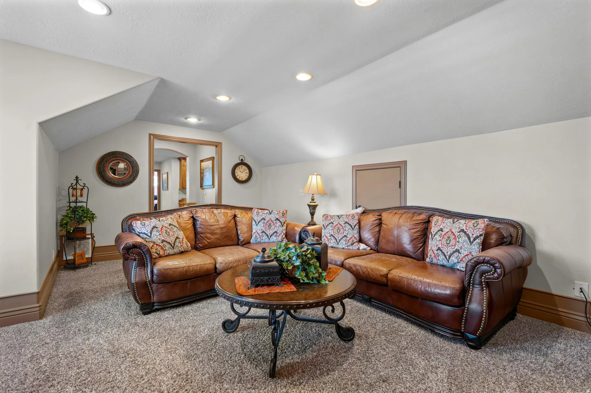 Carpeted room with recessed lighting and sloped ceilings