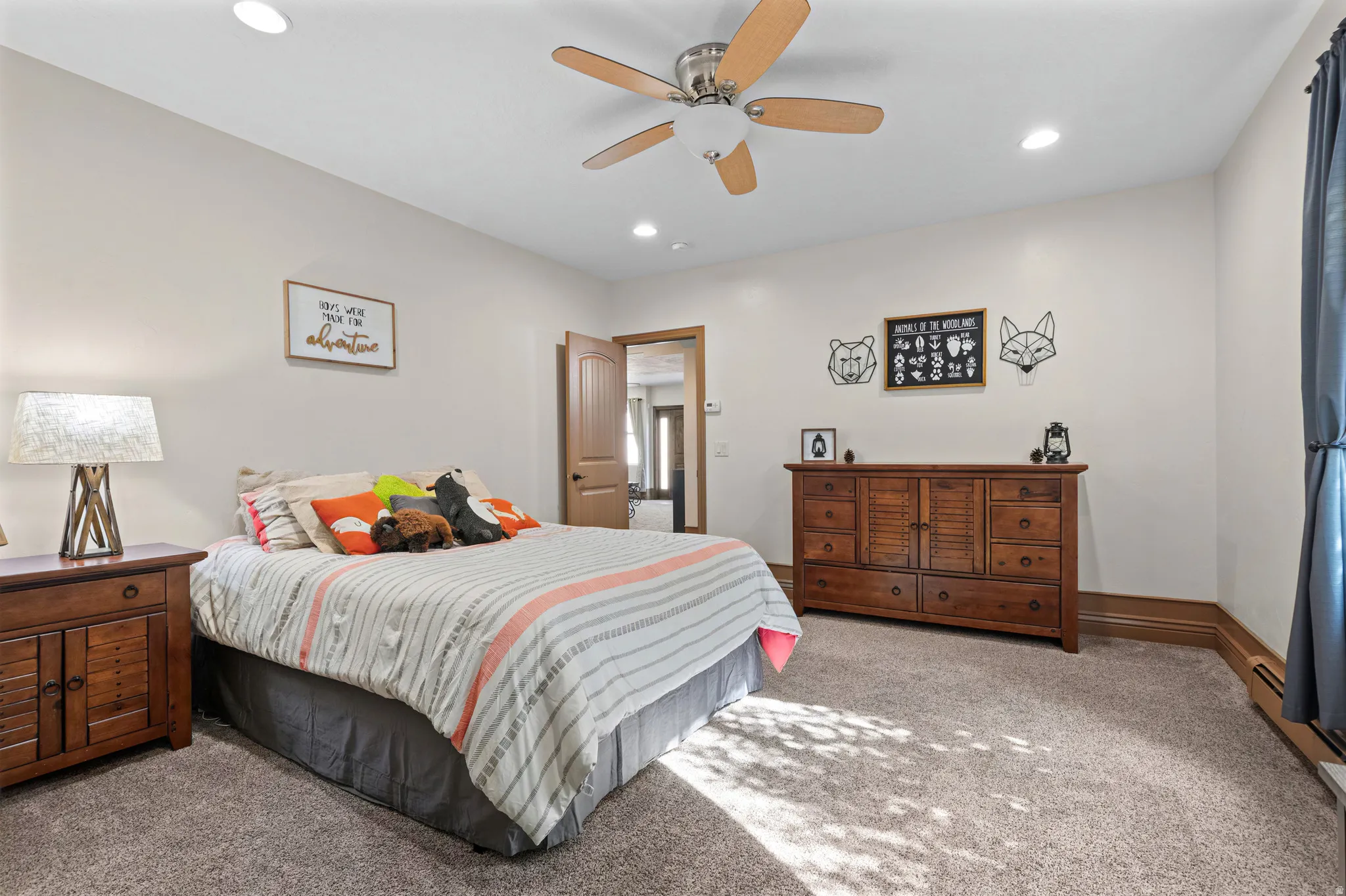 Spacious room featuring neutral walls, recessed lighting, a ceiling fan, wood-finish trim, and plush carpet flooring