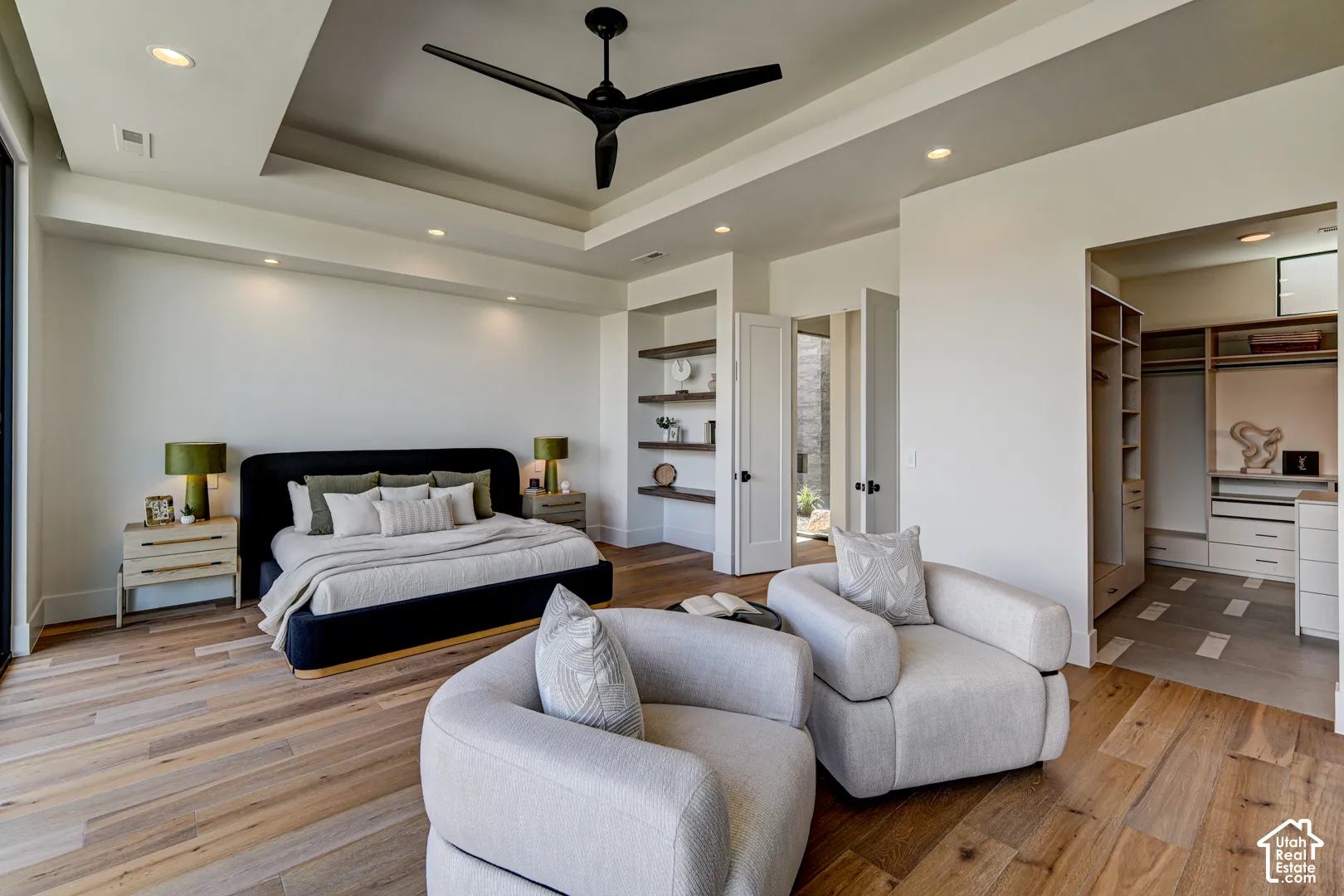 Recessed lighting, wood-finish flooring, tray ceiling, custom built-in shelving, and a custom built-in closet system