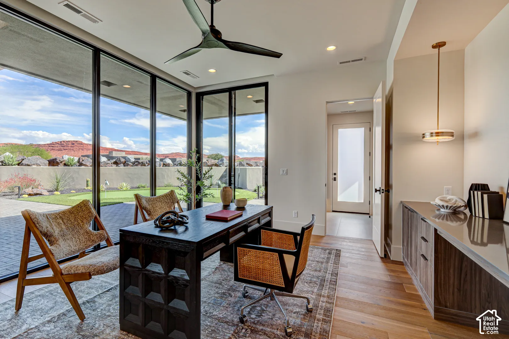 Floor-to-ceiling windows, outdoor patio, built-in cabinetry with counter, wood-finish flooring, and recessed lighting