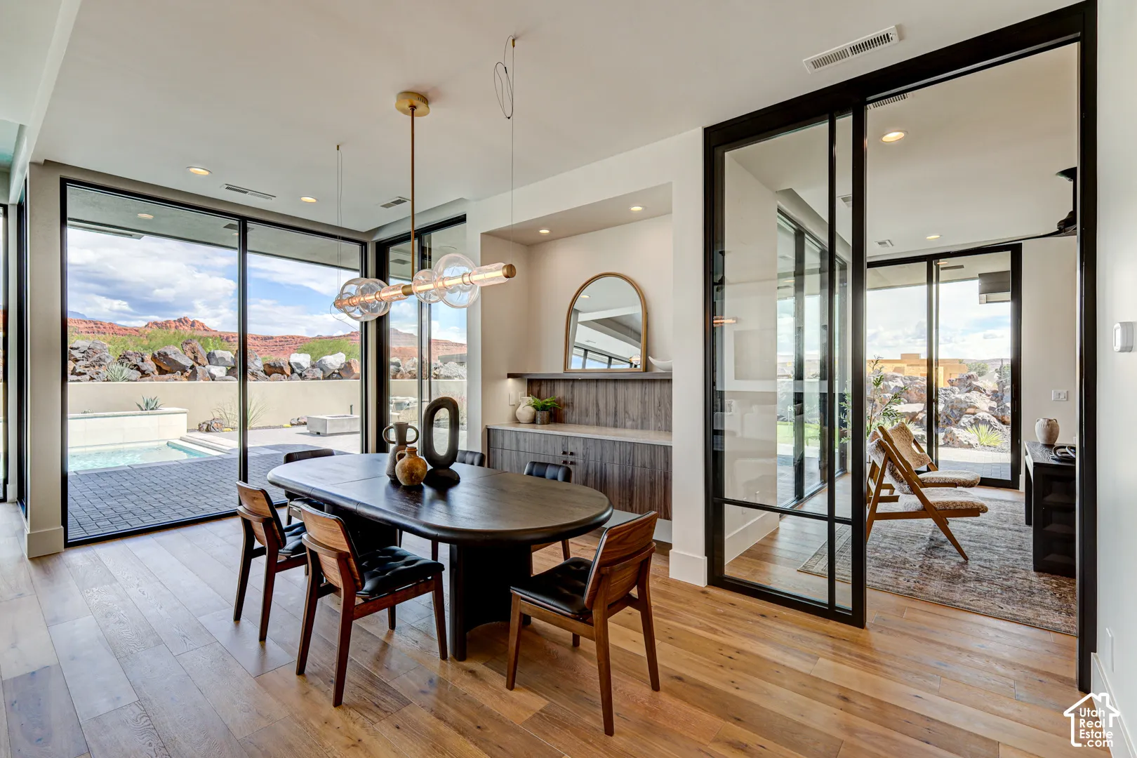 Wide plank wood-finish flooring, built-in cabinetry, large format sliding glass doors, built-in shelving, and recessed lighting