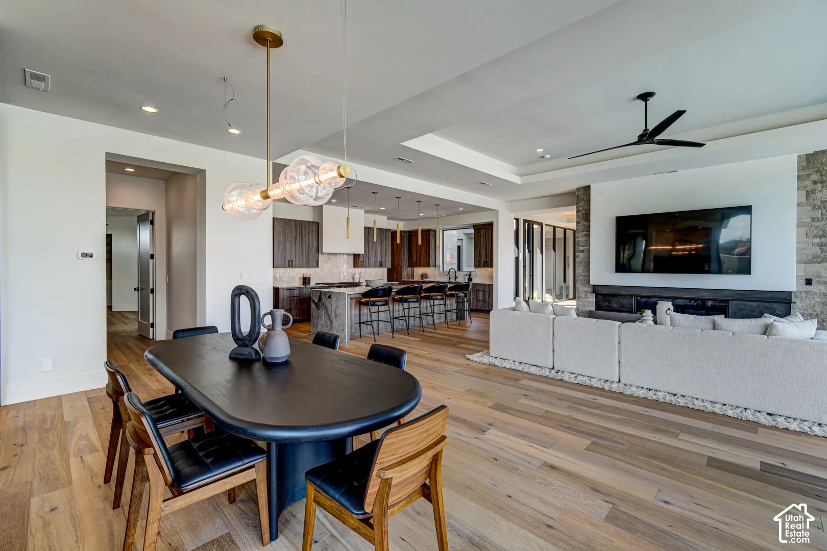 Hardwood flooring, recessed lighting, and a modern chandelier