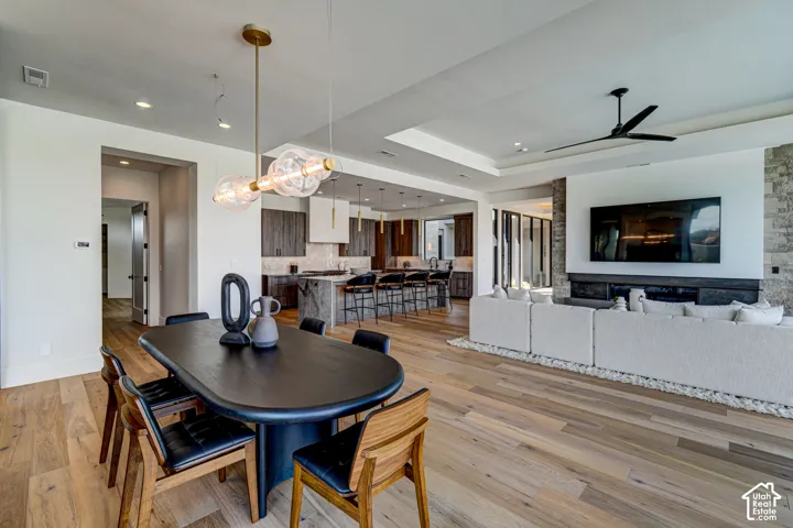 Hardwood flooring, recessed lighting, and a modern chandelier