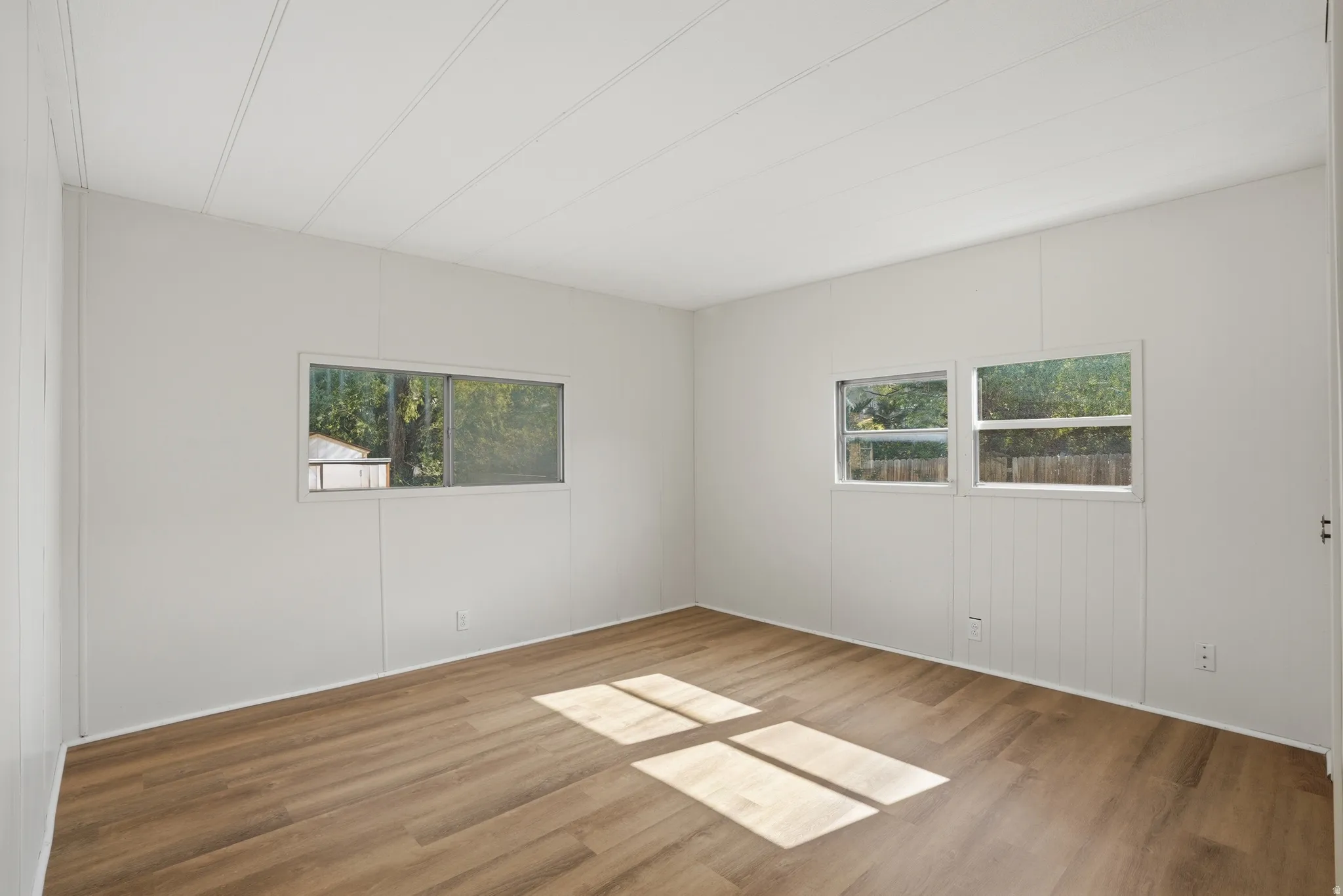 Neutral wall paneling with wood-finish flooring