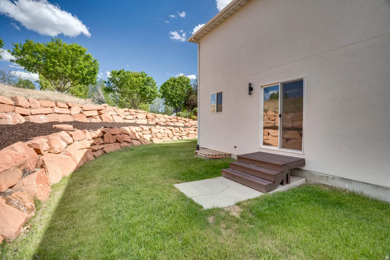 Rear exterior featuring stucco siding and a sliding glass door