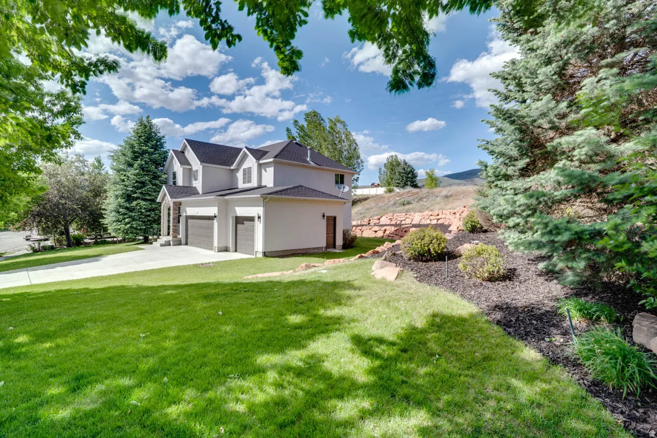 Contemporary two-story exterior with a two-car garage and a separate single-car garage