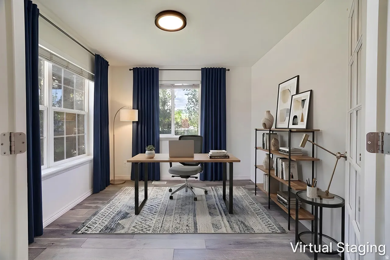 Bright room with two windows, wood-finish flooring, and a flush-mount ceiling light