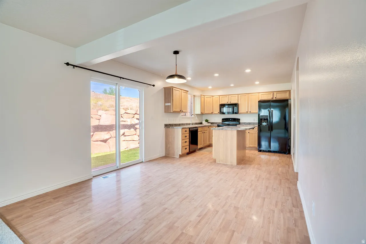 Open concept kitchen and dining area featuring wood-finish flooring